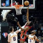 New Orleans Pelicans forward Herbert Jones, middle, scores on a shot from between Phoenix Suns forward Frank Kaminsky (8) and guard Chris Paul (3) during the first half of an NBA basketball game Tuesday, Nov. 2, 2021, in Phoenix. (AP Photo/Ross D. Franklin)