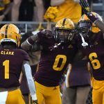 Arizona State defensive back Jack Jones (0) celebrates with defensive back Jordan Clark and defensive back Tommi Hill (6) after having a pick-6 against Arizona in the second half during an NCAA college football game, Saturday, Nov. 27, 2021, in Tempe, Ariz. (AP Photo/Rick Scuteri)