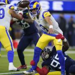Los Angeles Rams quarterback Matthew Stafford, above, tries to get away from Tennessee Titans defensive end Jeffery Simmons before throwing an interception during the first half of an NFL football game Sunday, Nov. 7, 2021, in Inglewood, Calif. (AP Photo/Ashley Landis)