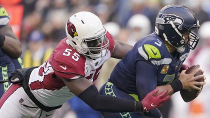 Seattle Seahawks quarterback Russell Wilson, right, is sacked by Arizona Cardinals' Chandler Jones ...