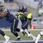 Seattle Seahawks' Alex Collins (41) carries against the Arizona Cardinals during the first half of an NFL football game, Sunday, Nov. 21, 2021, in Seattle. (AP Photo/John Froschauer)
