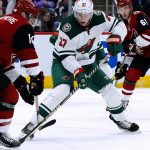 Minnesota Wild center Nick Bjugstad (27) has his shot stopped by Arizona Coyotes defenseman Shayne Gostisbehere, left, as Coyotes defenseman Dysin Mayo (61) watches during the second period of an NHL hockey game Wednesday, Nov. 10, 2021, in Glendale, Ariz. (AP Photo/Ross D. Franklin)