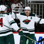 Minnesota Wild left wing Marcus Foligno, right, celebrates his goal against the Arizona Coyotes with defenseman Jon Merrill (4) during the first period of an NHL hockey game Wednesday, Nov. 10, 2021, in Glendale, Ariz. (AP Photo/Ross D. Franklin)