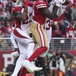 San Francisco 49ers wide receiver Brandon Aiyuk (11) catches a touchdown pass against Arizona Cardinals cornerback Robert Alford, left, and free safety Jalen Thompson (34) during the second half of an NFL football game in Santa Clara, Calif., Sunday, Nov. 7, 2021. (AP Photo/Jed Jacobsohn)