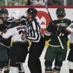 Minnesota Wild right wing Ryan Hartman (38) confronts Arizona Coyotes right wing Christian Fischer (36) during the first period of an NHL hockey game Tuesday, Nov. 30, 2021, in St. Paul, Minn. (AP Photo/Stacy Bengs)