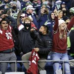 Arizona Cardinals fans cheer after their team beat the Seattle Seahawks in an NFL football game, Sunday, Nov. 21, 2021, in Seattle. The Cardinals won 23-13. (AP Photo/John Froschauer)