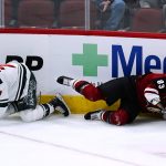 Arizona Coyotes center Jay Beagle (83) falls to the ice over Minnesota Wild center Nico Sturm (7) during the third period of an NHL hockey game Wednesday, Nov. 10, 2021, in Glendale, Ariz. The Wild won 5-2. (AP Photo/Ross D. Franklin)