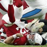 
              Arizona Cardinals quarterback Colt McCoy flips over after fumbling the ball to the Carolina Panthers during the first half of an NFL football game Sunday, Nov. 14, 2021, in Glendale, Ariz. (AP Photo/Ralph Freso)
            