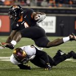 
              Oregon State running back B.J. Baylor (4) runs over Arizona State defensive back Jack Jones (0) during the second quarter of an NCAA college football game Saturday, Nov. 20, 2021, in Corvallis, Ore. (AP Photo/Andy Nelson)
            