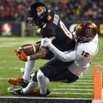 Oregon State wide receiver Tre'Shaun Harrison (0) gets into the end zone as Arizona State defensive back Kejuan Markham (12) tries to make the stop during the second quarter of an NCAA college football game Saturday, Nov. 20, 2021, in Corvallis, Ore. (AP Photo/Andy Nelson)