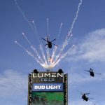 Washington state Army National Guard helicopters fly over the stadium before an NFL football game between the Seattle Seahawks and the Arizona Cardinals during a Salute to Service event, Sunday, Nov. 21, 2021, in Seattle. (AP Photo/John Froschauer)