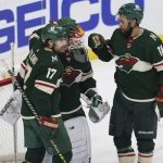 Minnesota Wild left wings Marcus Foligno (17) and Jordan Greenway (18) gather around goaltender Kaapo Kahkonen (34) in celebration after the team's 5-2 win over against the Arizona Coyotes in an NHL hockey game Tuesday, Nov. 30, 2021, in St. Paul, Minn. (AP Photo/Stacy Bengs)