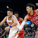 New Orleans Pelicans center Jaxson Hayes (10) strips the ball from Phoenix Suns guard Devin Booker as Pelicans guard Nickeil Alexander-Walker watches during the first half of an NBA basketball game Tuesday, Nov. 2, 2021, in Phoenix. (AP Photo/Ross D. Franklin)