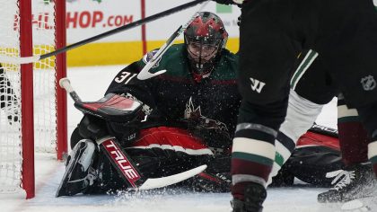 Arizona Coyotes goalie Scott Wedgewood (31) covers up the puck while making a save against the Dall...
