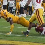 Arizona State running back Rachaad White (3) stretches for the end zone and scores against Southern California safety Xavion Alford (29) during the second half of an NCAA college football game Saturday, Nov. 6, 2021, in Tempe, Ariz. (AP Photo/Darryl Webb)