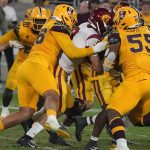 Arizona State defensive linemen Anthonie Cooper (96) and Omarr Norman-Lott (55) wrap up Southern California quarterback Kedon Slovis (9) during the second half of an NCAA college football game Saturday, Nov. 6, 2021, in Tempe, Ariz. (AP Photo/Darryl Webb)