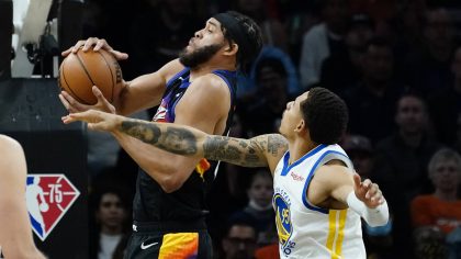 Phoenix Suns center JaVale McGee shoots as Golden State Warriors forward Juan Toscano-Anderson, rig...
