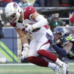Arizona Cardinals' Zach Ertz heads into the end zone to score a touchdown as Seattle Seahawks' Sidney Jones defends during the first half of an NFL football game, Sunday, Nov. 21, 2021, in Seattle. (AP Photo/Ted S. Warren)