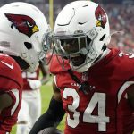 Arizona Cardinals free safety Jalen Thompson (34) celebrates his interception against the Carolina Panthers with Cardinals defensive back Chris Banjo (31) during the first half of an NFL football game Sunday, Nov. 14, 2021, in Glendale, Ariz. (AP Photo/Darryl Webb)