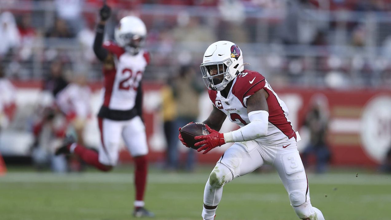 Arizona Cardinals safety Budda Baker, right, returns an interception during the second half of an N...