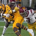 Arizona State running back Rachaad White (3) gets wrapped up by Southern California's Calen Bullock and Chase Williams (7) during the first half of an NCAA college football game Saturday, Nov. 6, 2021, in Tempe, Ariz. (AP Photo/Darryl Webb)
