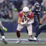 Arizona Cardinals' Zach Ertz (86) aims for a hole against the Seattle Seahawks as he runs with the ball during the first half of an NFL football game, Sunday, Nov. 21, 2021, in Seattle. (AP Photo/John Froschauer)