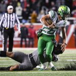 Oregon running back Travis Dye (26) is tackled by Utah linebacker Nephi Sewell (1) during the second half of an NCAA college football game Saturday, Nov. 20, 2021, in Salt Lake City. (AP Photo/Alex Goodlett)