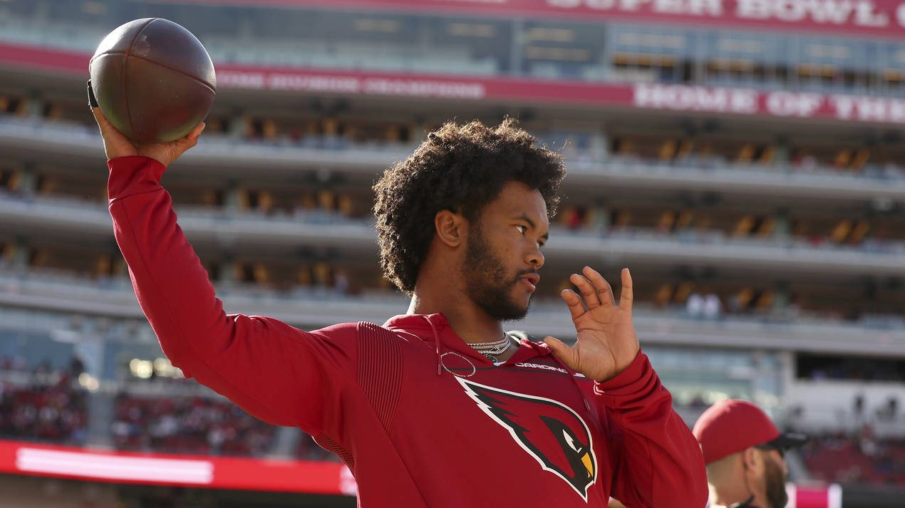 Inactive Arizona Cardinals quarterback Kyler Murray throws a pass on the sideline before an NFL foo...