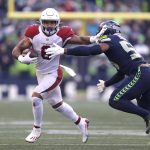 Seattle Seahawks' Jordyn Brooks, right, chases Arizona Cardinals' James Conner during the first half of an NFL football game, Sunday, Nov. 21, 2021, in Seattle. (AP Photo/John Froschauer)
