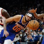 Phoenix Suns center JaVale McGee (00) and guard Chris Paul (3) chase a loose ball as Portland Trail Blazers forward Nassir Little (9) looks on during the first half of an NBA basketball game, Wednesday, Nov. 10, 2021, in Phoenix. (AP Photo/Matt York)