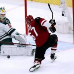 Minnesota Wild goaltender Kaapo Kahkonen (34) makes a save on a shot by Arizona Coyotes left wing Lawson Crouse (67) during the third period of an NHL hockey game Wednesday, Nov. 10, 2021, in Glendale, Ariz. The Wild won 5-2. (AP Photo/Ross D. Franklin)