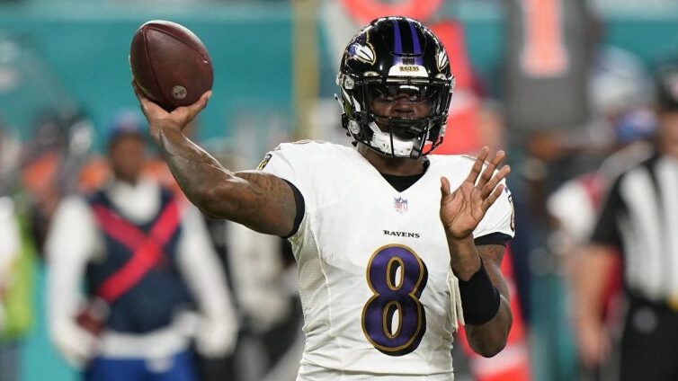 Baltimore Ravens quarterback Lamar Jackson (8) aims a pass during the first half of an NFL football...