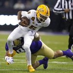 Arizona State quarterback Jayden Daniels (5) is brought down by Washington's Mason West on a carry during the first half of an NCAA college football game Saturday, Nov. 13, 2021, in Seattle. (AP Photo/Elaine Thompson)