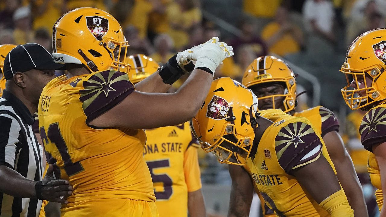 Arizona State running back Rachaad White (3) gets crowned by his offensive lineman Dohnovan West (6...