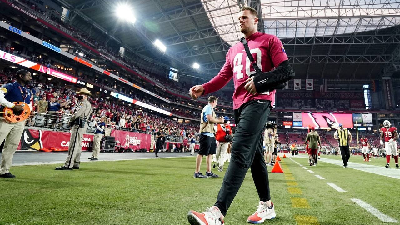 An injured Arizona Cardinals defensive end J.J. Watt walks off the field after an NFL football game...