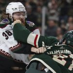 Arizona Coyotes center Liam O'Brien (38) and Minnesota Wild right wing Brandon Duhaime (21) fight during the second period of an NHL hockey game Tuesday, Nov. 30, 2021, in St. Paul, Minn. (AP Photo/Stacy Bengs)