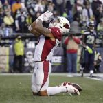 Arizona Cardinals running back James Conner kneels in the end zone after scoring a touchdown against the Seattle Seahawks late in the second half of an NFL football game, Sunday, Nov. 21, 2021, in Seattle. (AP Photo/Ted S. Warren)