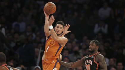 Phoenix Suns' Devin Booker (1) looks to pass over New York Knicks' Julius Randle (30) during the fi...