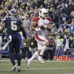 Arizona Cardinals running back James Conner runs in for a touchdown against the Seattle Seahawks late in the second half of an NFL football game, Sunday, Nov. 21, 2021, in Seattle. (AP Photo/John Froschauer)