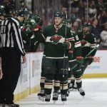 Minnesota Wild defenseman Jonas Brodin (25) high-fives teammates on the bench after scoring a goal against the Arizona Coyotes during the second period of an NHL hockey game Tuesday, Nov. 30, 2021, in St. Paul, Minn. Minnesota won 5-2. (AP Photo/Stacy Bengs)