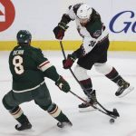 Arizona Coyotes center Liam O'Brien (38) defends against Minnesota Wild defenseman Jordie Benn (8) during the first period of an NHL hockey game Tuesday, Nov. 30, 2021, in St. Paul, Minn. (AP Photo/Stacy Bengs)