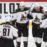 Arizona Coyotes defenseman Anton Stralman (86) is surrounded by teammates after scoring a goal during the third period of the team's NHL hockey game against the Minnesota Wild, Tuesday, Nov. 30, 2021, in St. Paul, Minn. Minnesota won 5-2. (AP Photo/Stacy Bengs)