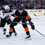 Philadelphia Flyers' Travis Sanheim (6) tries to keep the puck away from Arizona Coyotes' Johan Larsson (22) during the second period of an NHL hockey game, Tuesday, Nov. 2, 2021, in Philadelphia. (AP Photo/Matt Slocum)