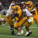 Arizona State running back DeaMonte Trayanum (1) bulls his way into the end zone against Southern California's Greg Johnson (1) and Chris Steele (8) during the first half of an NCAA college football game Saturday, Nov. 6, 2021, in Tempe, Ariz. (AP Photo/Darryl Webb)