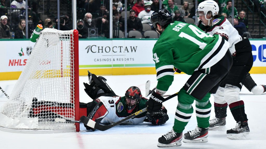 Jamie Benn #14 of the Dallas Stars flips a puck up and over Scott Wedgewood #31 for a goal against ...