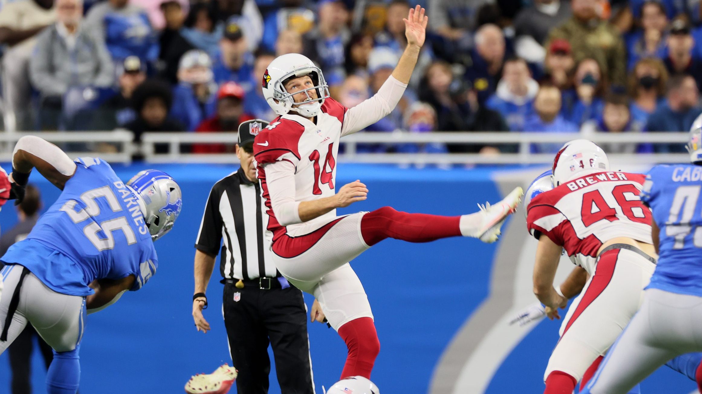 Arizona Cardinals punter Andy Lee (14) follows his kick during an NFL football game between the Det...