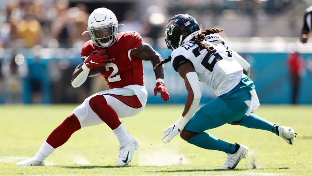 Chase Edmonds #2 of the Arizona Cardinals runs the ball and looks to avoid a tackle by Chris Claybr...