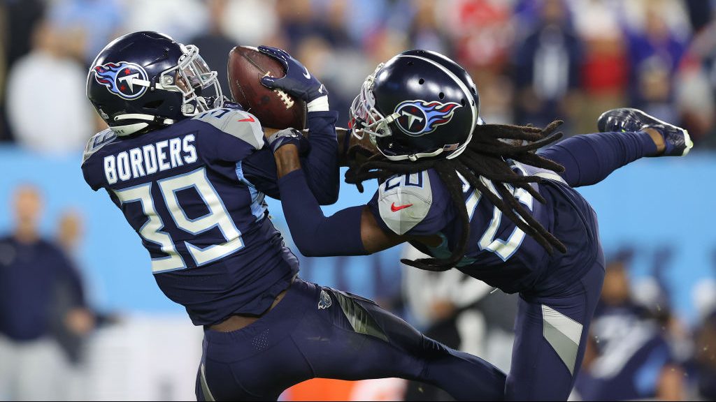 Breon Borders #39 and Janoris Jenkins #20 of the Tennessee Titans reach up to intercept a pass agai...