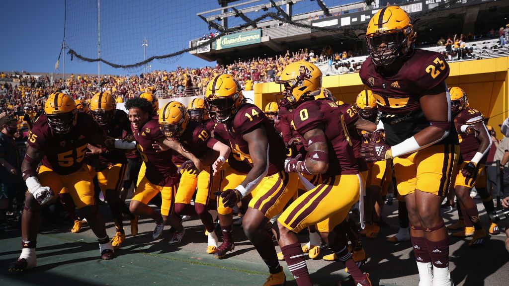 The Arizona State Sun Devils run onto the field before the Territorial Cup game against the Arizona...