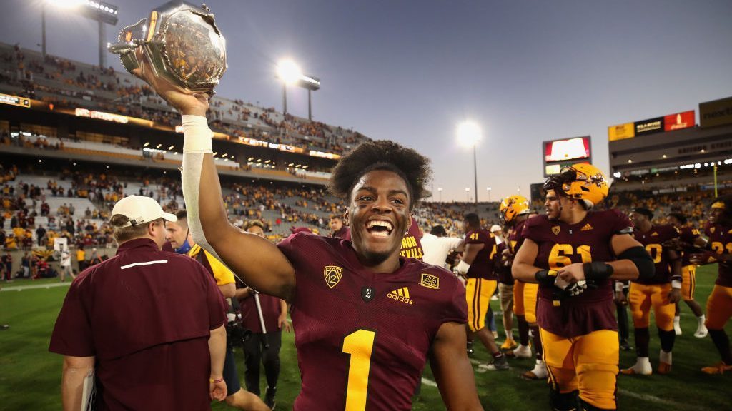 Defensive back Jordan Clark #1 of the Arizona State Sun Devils celebrates with the Territorial Cup ...